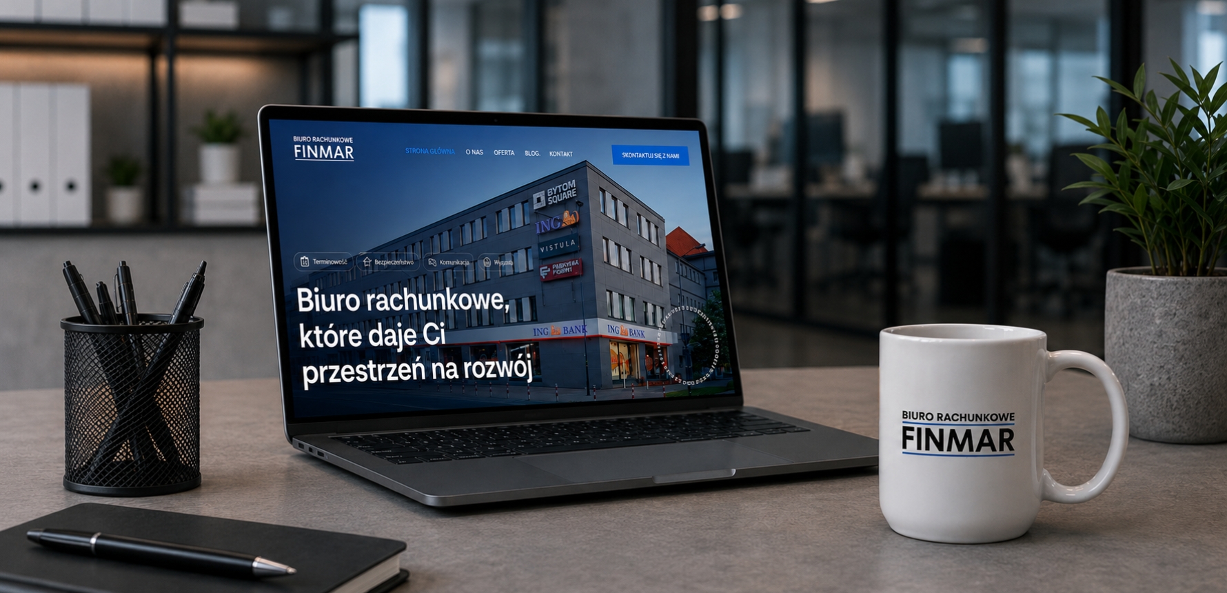 Laptop z hasłem biura FINMAR i firmowy kubek na biurku